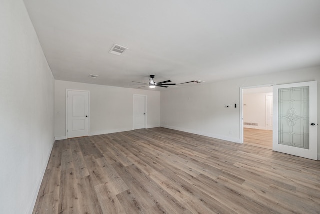 509 Twilight Dr, Garland, TX 75040 - spare room featuring a ceiling fan, light wood-style floors, and baseboards