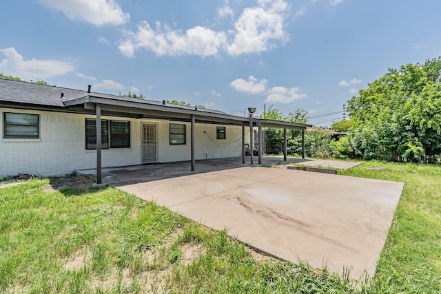 509 Twilight Dr, Garland, TX 75040 - rear view of property with brick siding, a lawn, and a carport