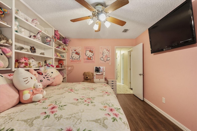 4225 Toledo Ave, Fort Worth, TX 76133 - bedroom with a textured ceiling, dark wood-type flooring, and ceiling fan