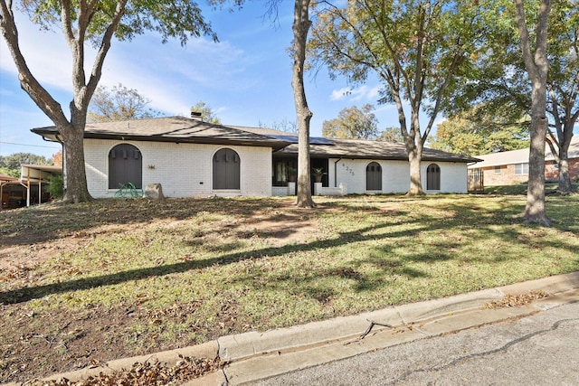 4225 Toledo Ave, Fort Worth, TX 76133 - single story home with solar panels, brick siding, a front yard, and a chimney