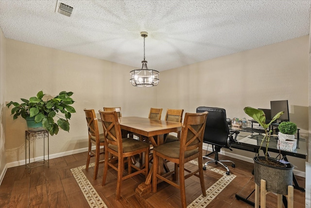 4225 Toledo Ave, Fort Worth, TX 76133 - dining space featuring a chandelier, baseboards, dark wood-type flooring, and a textured ceiling