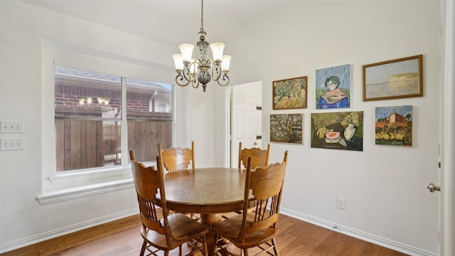 1607 Woodstream Ln, Allen, TX 75002 - dining space featuring a chandelier, wood finished floors, and baseboards