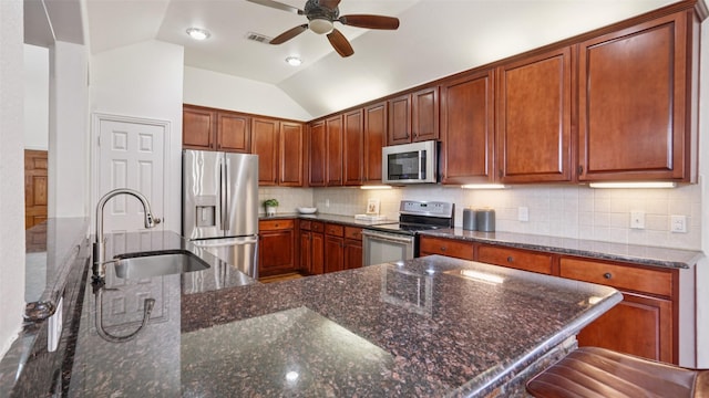 1607 Woodstream Ln, Allen, TX 75002 - kitchen featuring stainless steel appliances, a sink, a ceiling fan, lofted ceiling, and decorative backsplash