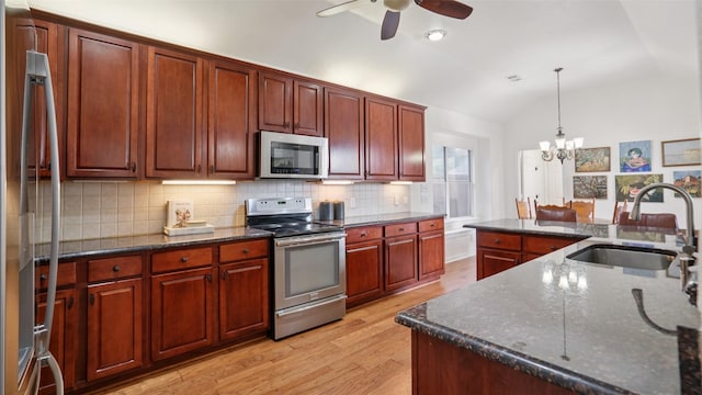 1607 Woodstream Ln, Allen, TX 75002 - kitchen featuring appliances with stainless steel finishes, a sink, vaulted ceiling, ceiling fan, and light wood finished floors