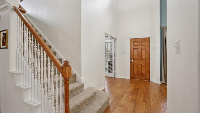 1607 Woodstream Ln, Allen, TX 75002 - entryway featuring light wood-style flooring, a high ceiling, baseboards, and stairs