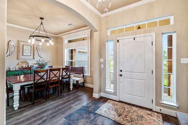 2355 Grindstone Rd, Millsap, TX 76066 - entryway with arched walkways, ornamental molding, baseboards, a chandelier, and dark stone finish floors