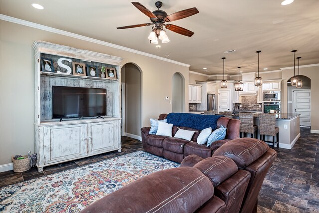 2355 Grindstone Rd, Millsap, TX 76066 - living area featuring baseboards, arched walkways, a ceiling fan, recessed lighting, and crown molding