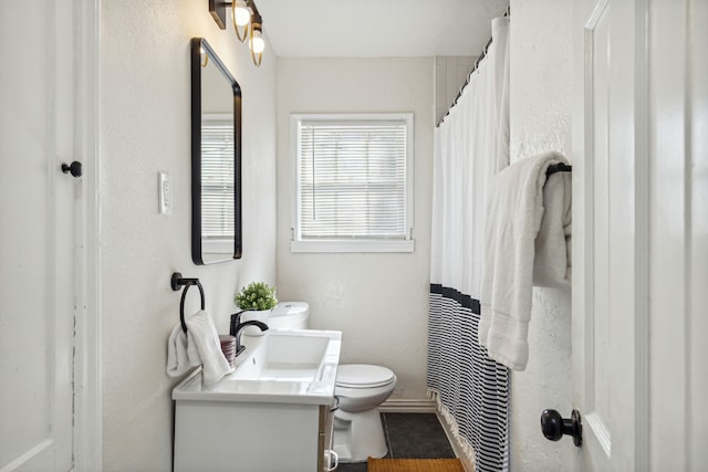 2435 W 10th St, Dallas, TX 75211 - bathroom with toilet, vanity, tile patterned floors, and a shower with curtain