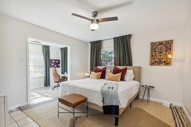 2435 W 10th St, Dallas, TX 75211 - bedroom featuring baseboards, a ceiling fan, and light tile patterned flooring
