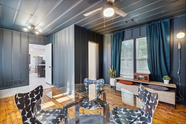 2435 W 10th St, Dallas, TX 75211 - dining space featuring ceiling fan, wood finished floors, and a decorative wall