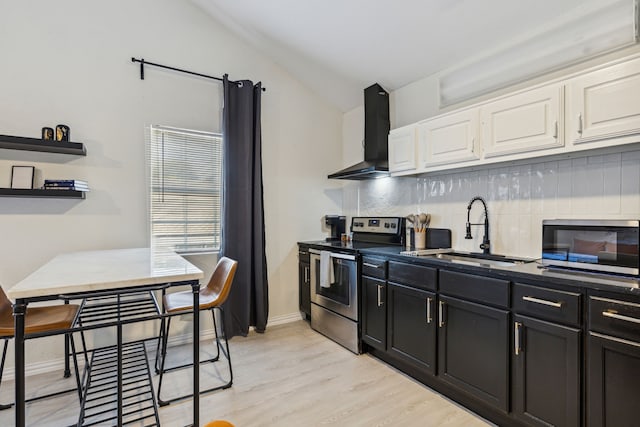 2435 W 10th St, Dallas, TX 75211 - kitchen featuring appliances with stainless steel finishes, wall chimney exhaust hood, a sink, white cabinets, and lofted ceiling
