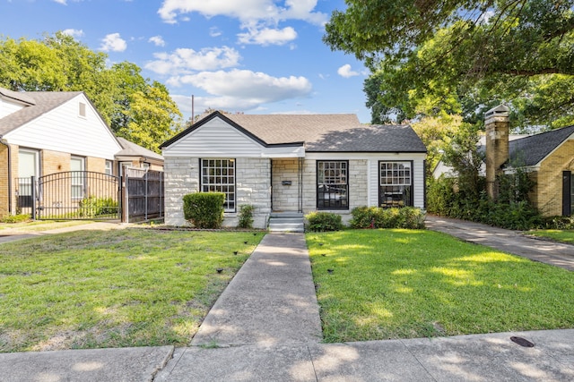 2435 W 10th St, Dallas, TX 75211 - view of front of home with a gate, stone siding, and a shingled roof