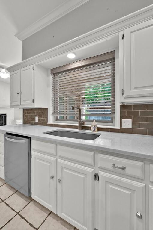 3009 Chimney Hill Dr, Waco, TX 76708 - kitchen featuring dishwasher, crown molding, a sink, light countertops, and decorative backsplash