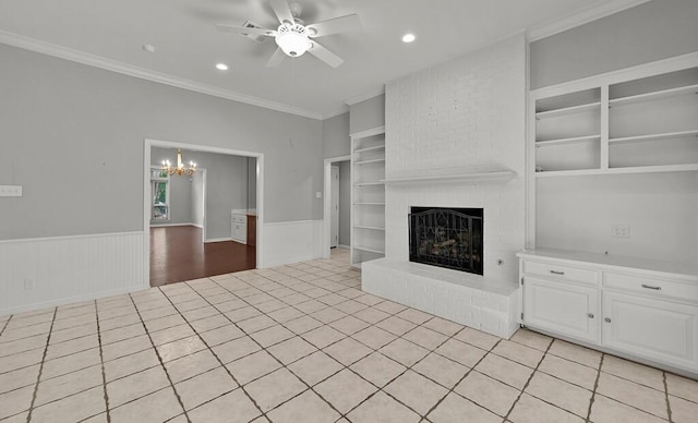 3009 Chimney Hill Dr, Waco, TX 76708 - unfurnished living room featuring a ceiling fan, built in shelves, a chandelier, a fireplace, and wainscoting