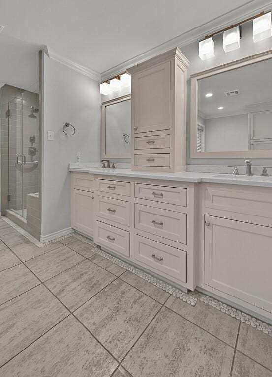 3009 Chimney Hill Dr, Waco, TX 76708 - bathroom featuring ornamental molding, double vanity, a shower stall, tile patterned floors, and baseboards