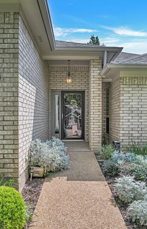 3009 Chimney Hill Dr, Waco, TX 76708 - doorway to property featuring brick siding and roof with shingles