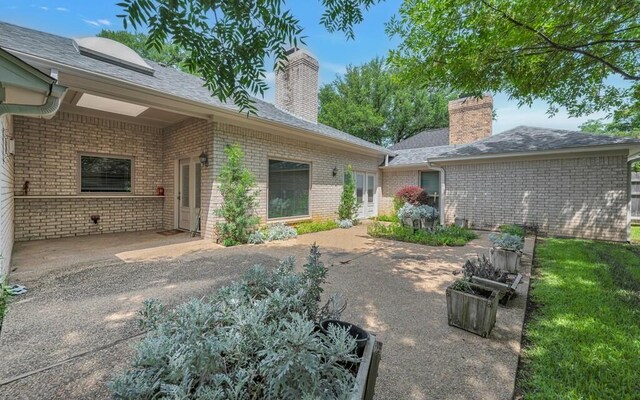 3009 Chimney Hill Dr, Waco, TX 76708 - rear view of property with a patio, brick siding, a chimney, and roof with shingles