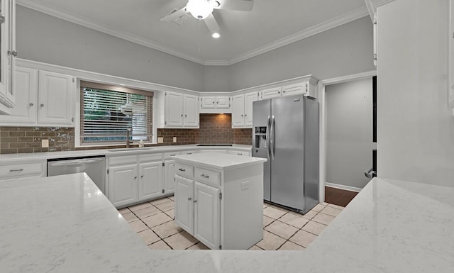 3009 Chimney Hill Dr, Waco, TX 76708 - kitchen with stainless steel appliances, a sink, ceiling fan, light tile patterned floors, and crown molding
