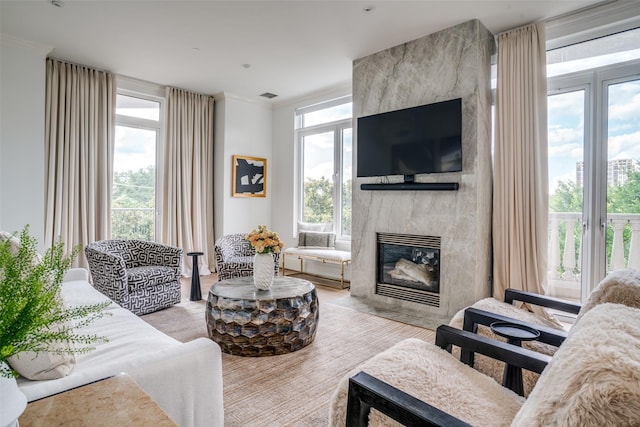 3505 Turtle Creek Blvd Unit 4F, Dallas, TX 75219 - living room with a fireplace, crown molding, and wood finished floors