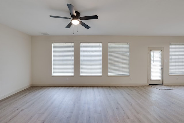 3037 Elmbrook Dr, Grand Prairie, TX 75052 - unfurnished room featuring a ceiling fan, wood finished floors, and baseboards