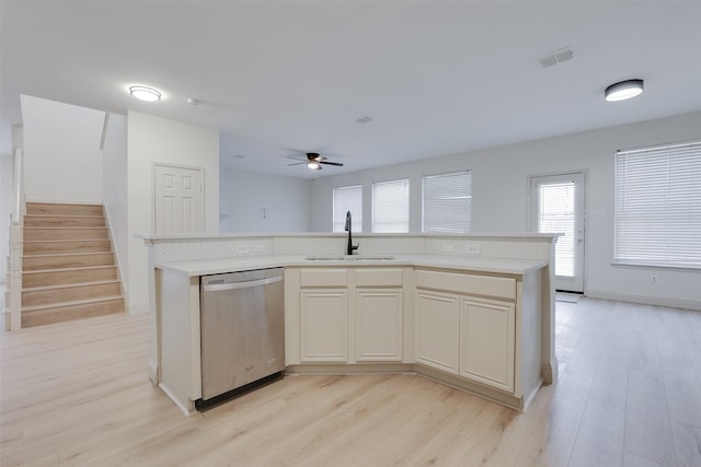 3037 Elmbrook Dr, Grand Prairie, TX 75052 - kitchen featuring stainless steel dishwasher, a sink, light wood finished floors, and a ceiling fan