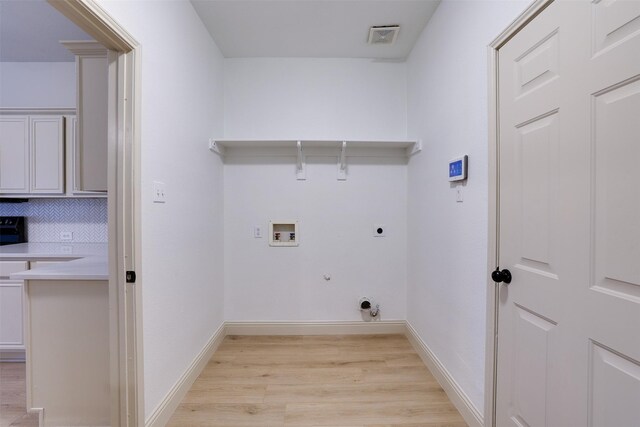 3037 Elmbrook Dr, Grand Prairie, TX 75052 - washroom featuring electric dryer hookup, gas dryer hookup, light wood-style floors, hookup for a washing machine, and baseboards