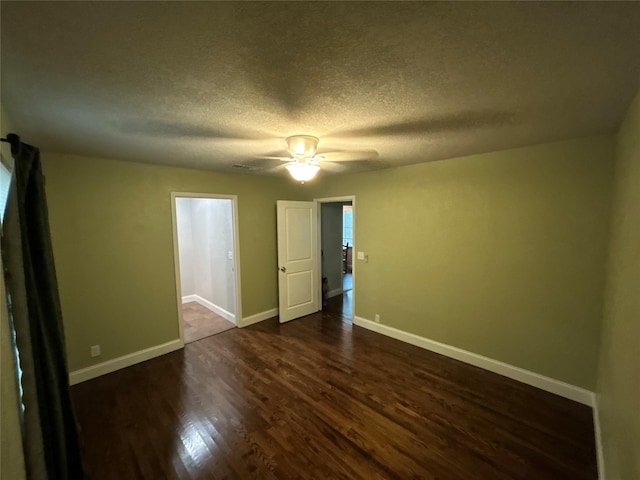 741 County Road 4681, Boyd, TX 76023 - empty room with dark wood-style flooring, baseboards, a ceiling fan, and a textured ceiling