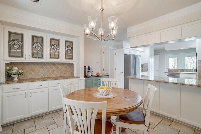 8921 Crest Ridge Dr, Fort Worth, TX 76179 - dining area featuring light stone finish flooring and a chandelier