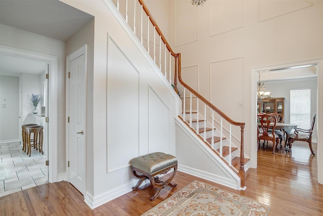 8921 Crest Ridge Dr, Fort Worth, TX 76179 - staircase featuring wood finished floors, a chandelier, and baseboards