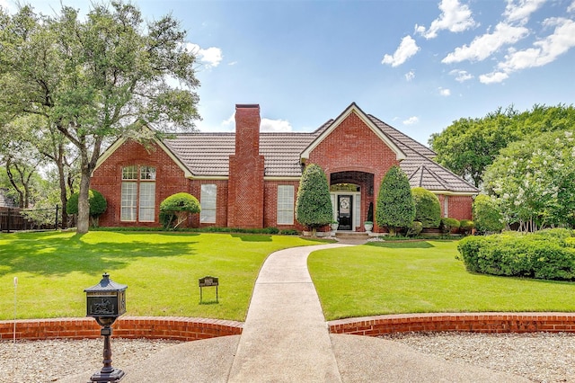 8921 Crest Ridge Dr, Fort Worth, TX 76179 - view of front of property featuring a tile roof, a chimney, a front yard, and brick siding