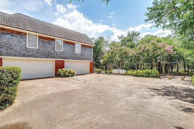 8921 Crest Ridge Dr, Fort Worth, TX 76179 - view of side of property featuring driveway, brick siding, and a garage