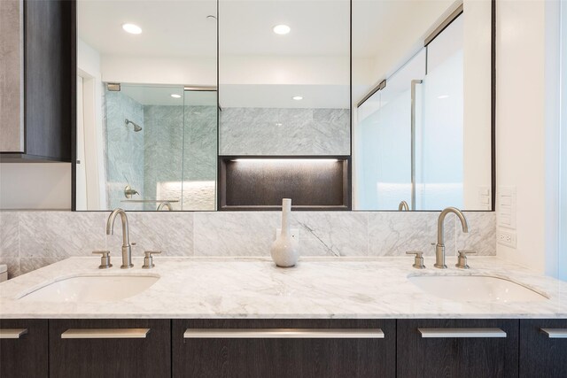 3130 N Harwood St Unit 1804, Dallas, TX 75201 - full bathroom with double vanity, decorative backsplash, and a shower with shower door