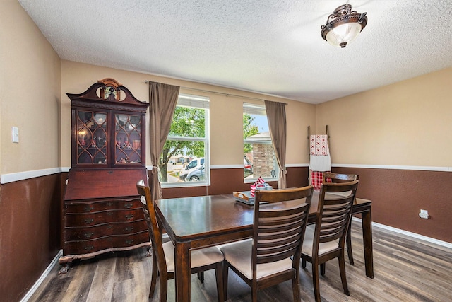 1400 Sunflower Ct, Burleson, TX 76028 - dining area with wood finished floors, a textured ceiling, and baseboards