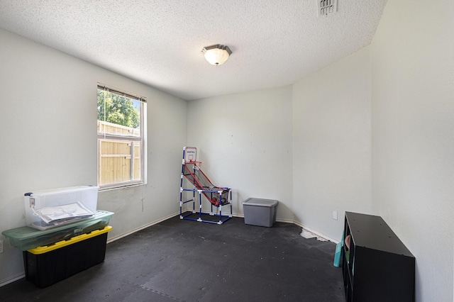 1400 Sunflower Ct, Burleson, TX 76028 - recreation room featuring a textured ceiling and baseboards