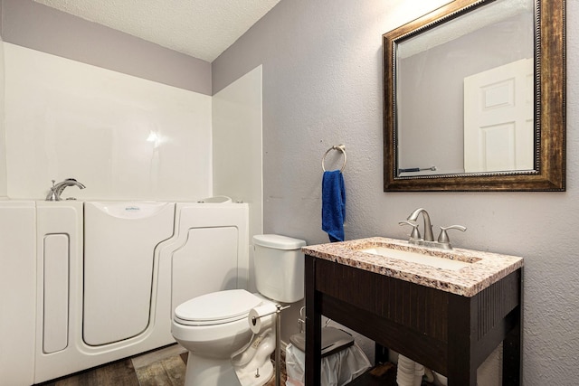 1400 Sunflower Ct, Burleson, TX 76028 - full bathroom with a textured ceiling, toilet, a garden tub, vanity, and wood finished floors