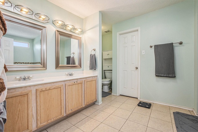 1400 Sunflower Ct, Burleson, TX 76028 - full bath with double vanity, toilet, a textured ceiling, tile patterned flooring, and baseboards
