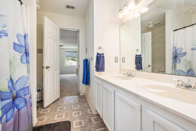 1400 Sunflower Ct, Burleson, TX 76028 - bathroom with double vanity and a textured ceiling