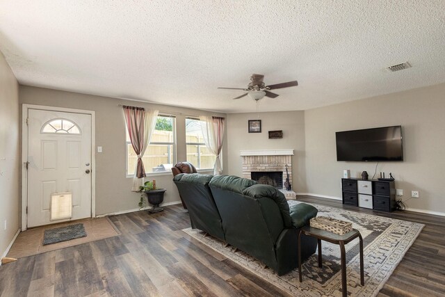 1400 Sunflower Ct, Burleson, TX 76028 - living room featuring a ceiling fan, a fireplace, dark wood-style flooring, a textured ceiling, and baseboards