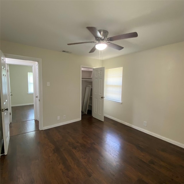 313 Wall St, Terrell, TX 75160 - unfurnished bedroom with wood finished floors, a closet, baseboards, and a ceiling fan