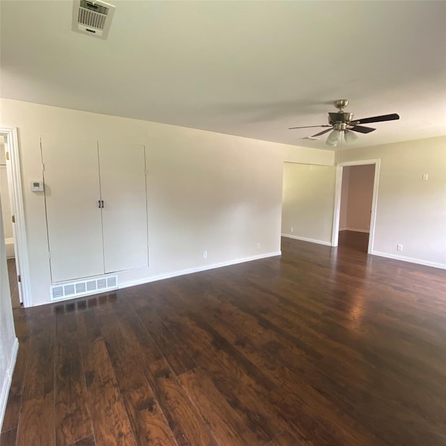 313 Wall St, Terrell, TX 75160 - empty room featuring dark wood-type flooring, a ceiling fan, and baseboards