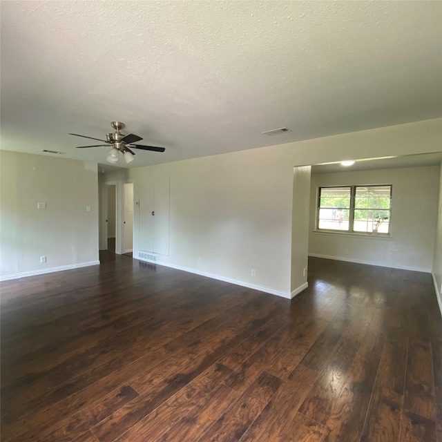 313 Wall St, Terrell, TX 75160 - unfurnished room featuring dark wood-style floors, a textured ceiling, baseboards, and a ceiling fan