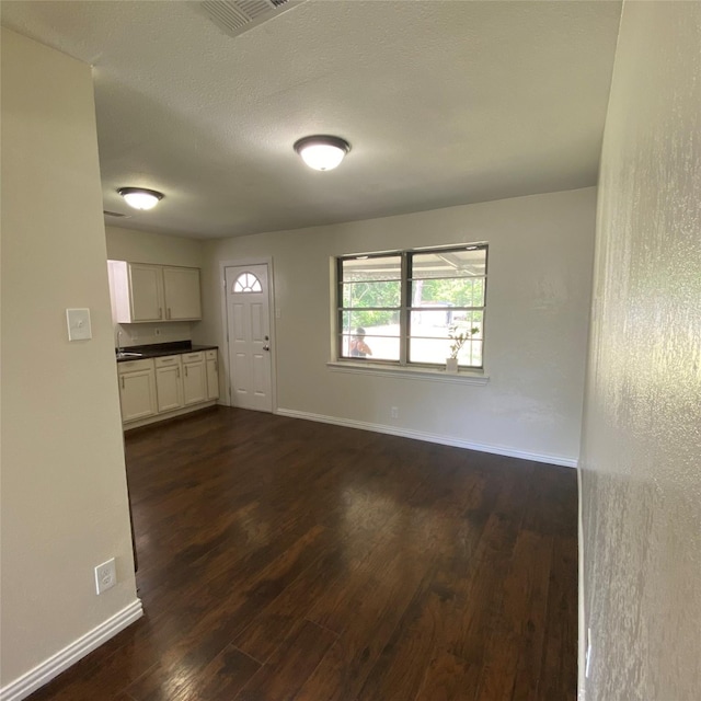 313 Wall St, Terrell, TX 75160 - entrance foyer with dark wood-type flooring and baseboards
