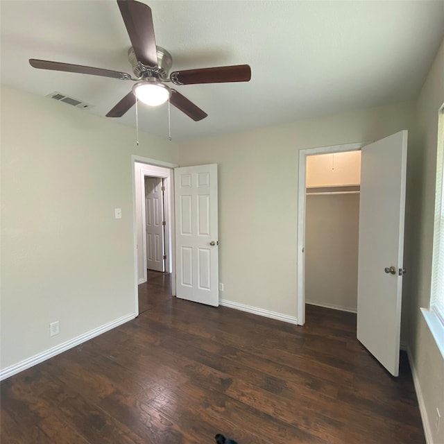 313 Wall St, Terrell, TX 75160 - unfurnished bedroom with dark wood-style flooring, baseboards, a ceiling fan, and a closet