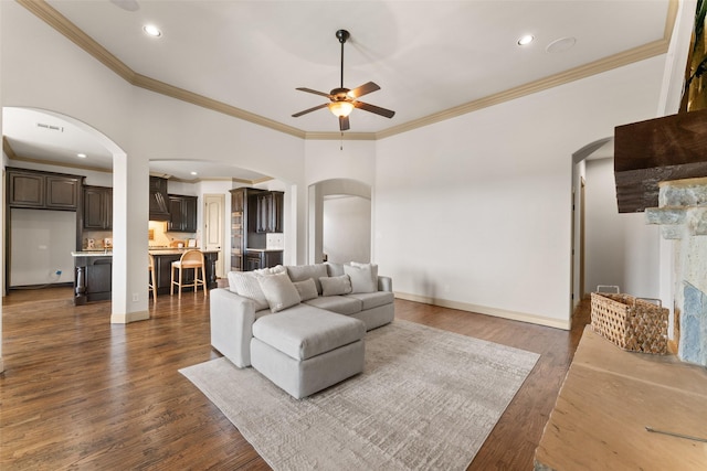 647 Gillon Way, Rockwall, TX 75087 - living area featuring arched walkways, ceiling fan, ornamental molding, dark wood-style floors, and recessed lighting