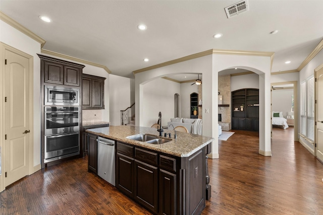 647 Gillon Way, Rockwall, TX 75087 - kitchen featuring appliances with stainless steel finishes, a sink, arched walkways, ceiling fan, and crown molding