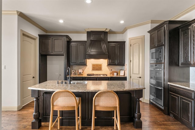 647 Gillon Way, Rockwall, TX 75087 - kitchen featuring stainless steel appliances, premium range hood, a kitchen bar, a sink, and recessed lighting