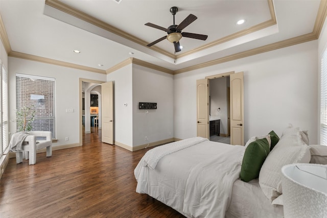 647 Gillon Way, Rockwall, TX 75087 - bedroom with wood finished floors, arched walkways, a raised ceiling, crown molding, and baseboards