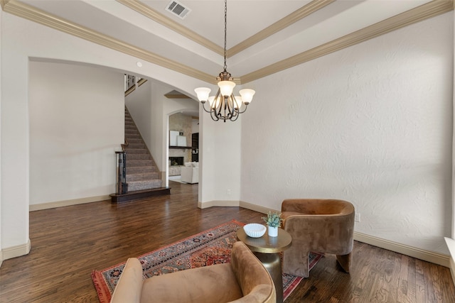 647 Gillon Way, Rockwall, TX 75087 - living room featuring arched walkways, wood finished floors, stairs, a chandelier, and crown molding
