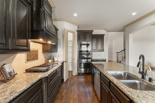 647 Gillon Way, Rockwall, TX 75087 - kitchen featuring stainless steel appliances, a sink, ornamental molding, custom range hood, and light stone counters