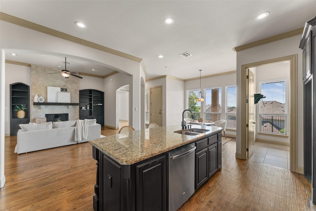 647 Gillon Way, Rockwall, TX 75087 - kitchen with stainless steel dishwasher, ceiling fan, a sink, crown molding, and a center island with sink
